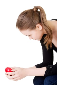 Pretty woman in depression holding small heart in her hand.