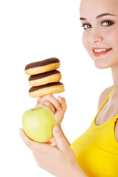 Donut or green apple - hard choice. Diet concept.