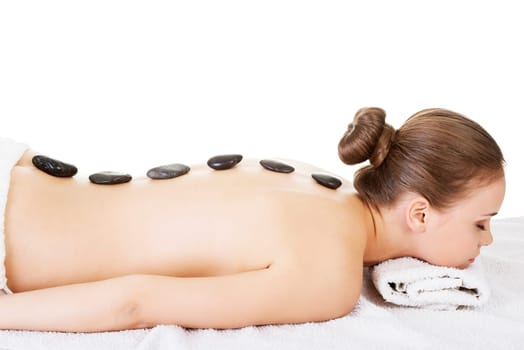 Beauty woman relaxing in spa. Stone massage. Isolateed.