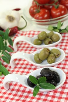 Olives with olive leaf on a spoon