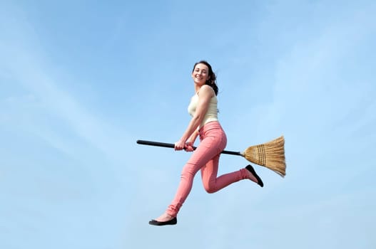 young woman flies with broom