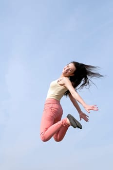 laughing woman makes leap of joy