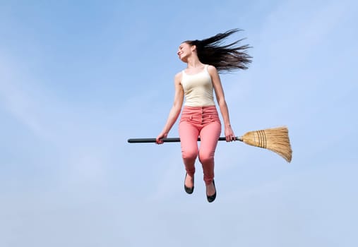 young woman flies with broom