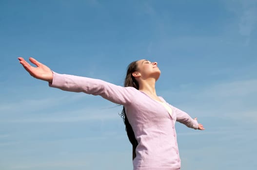 happy woman with outstretched arms feels free
