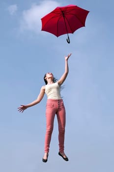 Woman jumps with umbrella