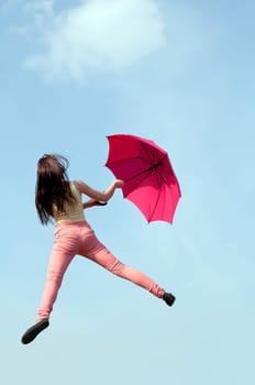 Woman jumps with umbrella