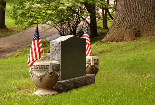 Tombstone with an American flag on either side