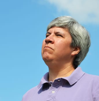 Older woman looking determinedly into the sky