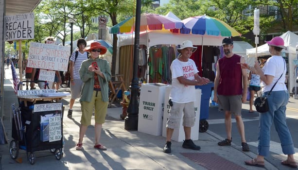 ANN ARBOR, MI - JULY 20: Supporters of an effort to recall Michigan Governor Rick Snyder work to gather petition signatures at the Ann Arbor Art Fair in Ann Arbor, MI  July 20-23, 2011.