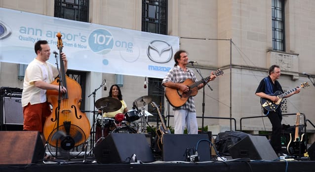 ANN ARBOR, MI – JULY 3: Dick Siegel, Dave Roof and Brian Delaney of Dick Siegel & the Brandos perform with drummer Gayelynn McKinney at the Ann Arbor Summer Festival July 3, 2012 in Ann Arbor, MI.