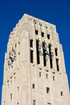 carillon bell tower with clock against blue sky - close-up
