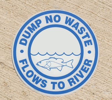 Drain sign "Dump no waste Flows to River"""