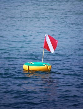 scuba flag on floater in bay