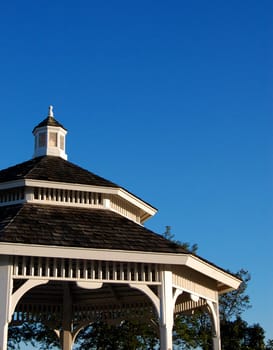 Roof of ornate gazebo with blue sky background