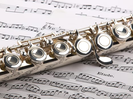 used flute rests across an open musical score. Only one line of music is in focus.