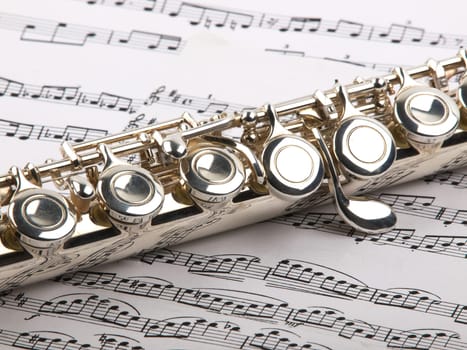 used flute rests across an open musical score. Only one line of music is in focus.