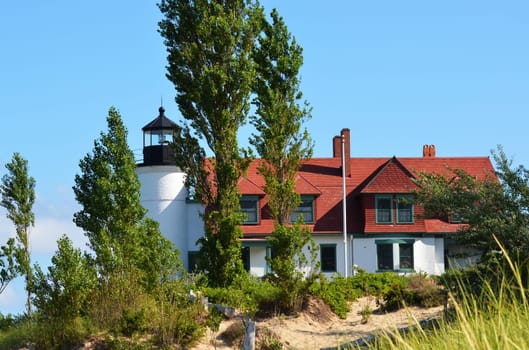 Pt. Betsie lighthouse, lake Michigan, with trees and sand dunes
