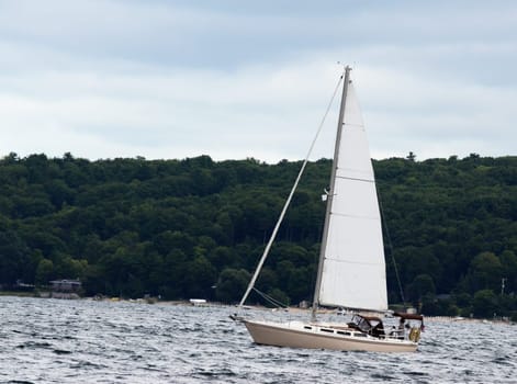 Sailboat in rough lake waters on a cloudy day
