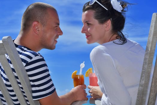 happy young couple relax and take fresh drink at summer vacation