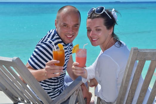 happy young couple relax and take fresh drink at summer vacation