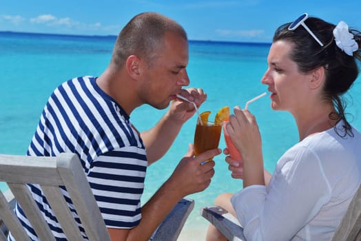 happy young couple relax and take fresh drink at summer vacation