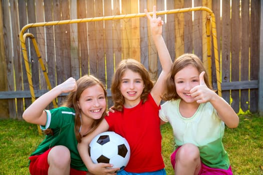 three sister girls friends soccer football winner players on the backyard
