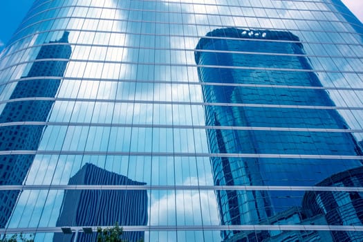 Houston downtown skyscrapers disctict with mirror blue sky reflection