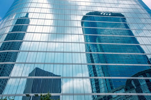 Houston downtown skyscrapers disctict with mirror blue sky reflection