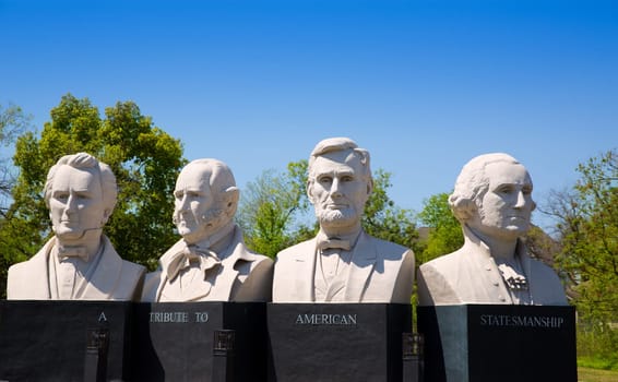 busts of four statesmen carved statues on Houston I-45