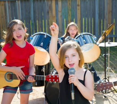 Blond kid singer girl singing playing live band in backyard concert with friends