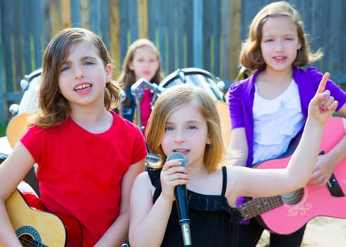 Blond kid singer girl singing playing live band in backyard concert with friends