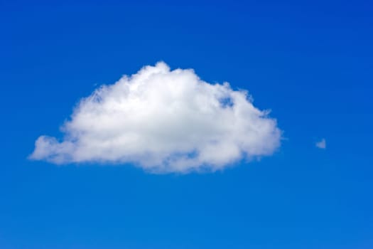 Single white cloud in a blue sky