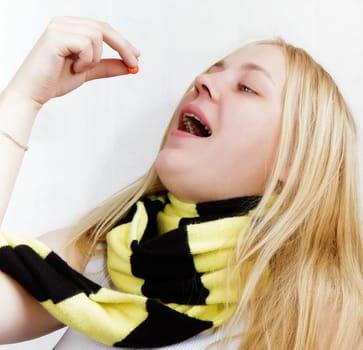 girl with pills, wrapped in a scarf. white background