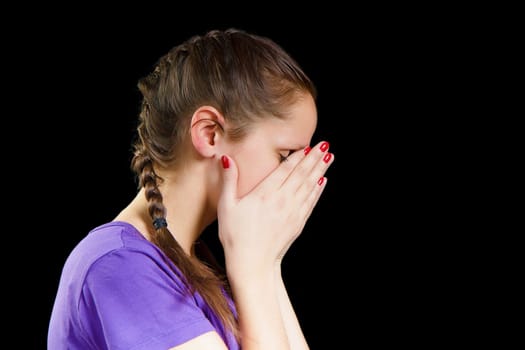 young woman covered her face with her hands