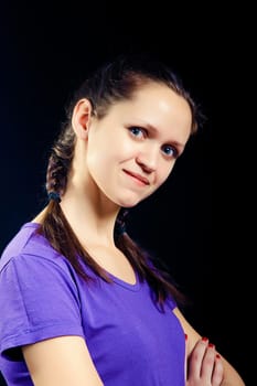 girl with pigtails in a T-shirt on a black background