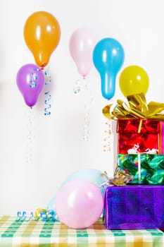 Holiday. Gifts and balloons on a white background