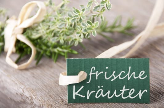 a green label with the german words frische Kräuter which means fresh herbs, herb background