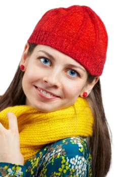 Portrait of a beautiful young woman with yellow scarf and red hat over white.
