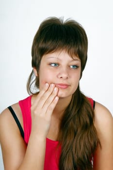 a young girl suffering from a toothache