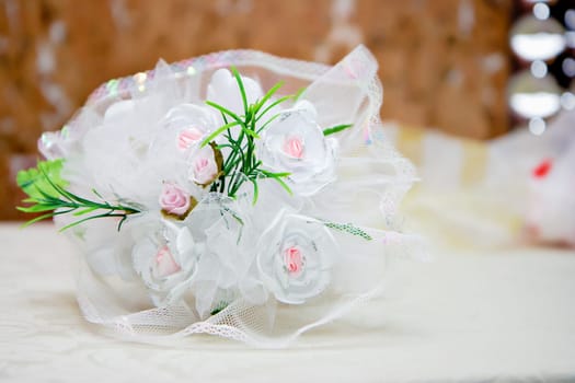 bridal bouquet of white lace with artificial flowers