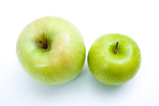 Two green apples on a light background