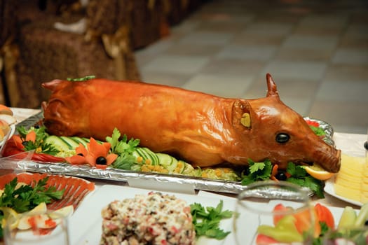 a beautiful roast suckling pig on the Serving Table