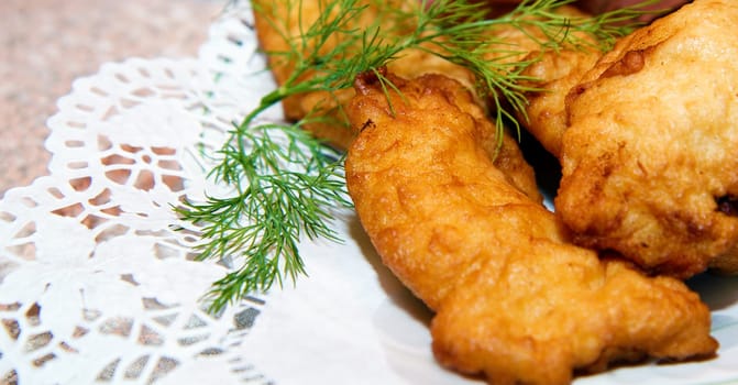 fish in batter on a plate. Festive table