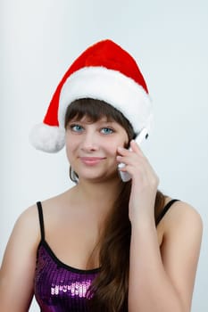 attractive girl in a Christmas hat talking on a cell phone