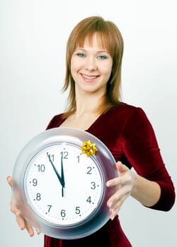 attractive girl with a clock on the eve of Christmas