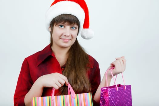 A girl in a Christmas hat with shopping