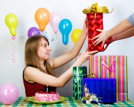 Birthday. The girl happily accepts gifts from friends