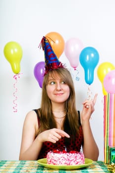 happy birthday. Joyful attractive girl and a festive table with cake