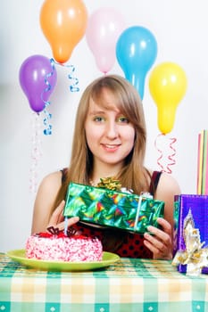 Birthday. Smiling girl with a gift in their hands