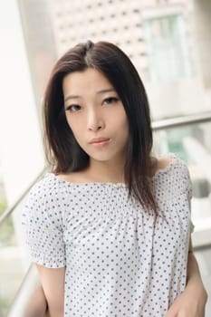 Attractive young woman, closeup glamour portrait at street in modern city, Taipei, Taiwan, Asia.